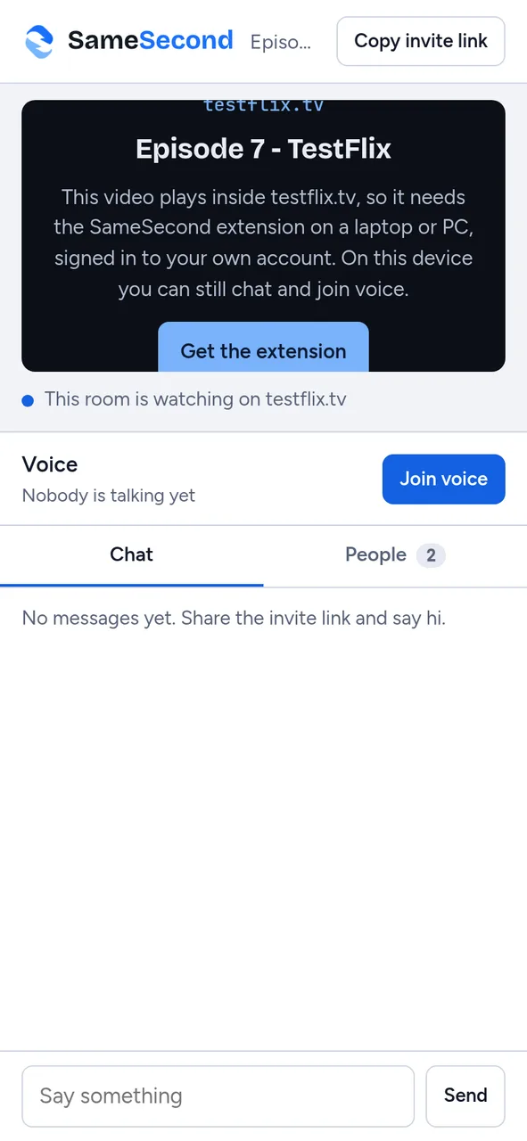 A phone in a room watching a streaming site, explaining the video needs the extension on a laptop